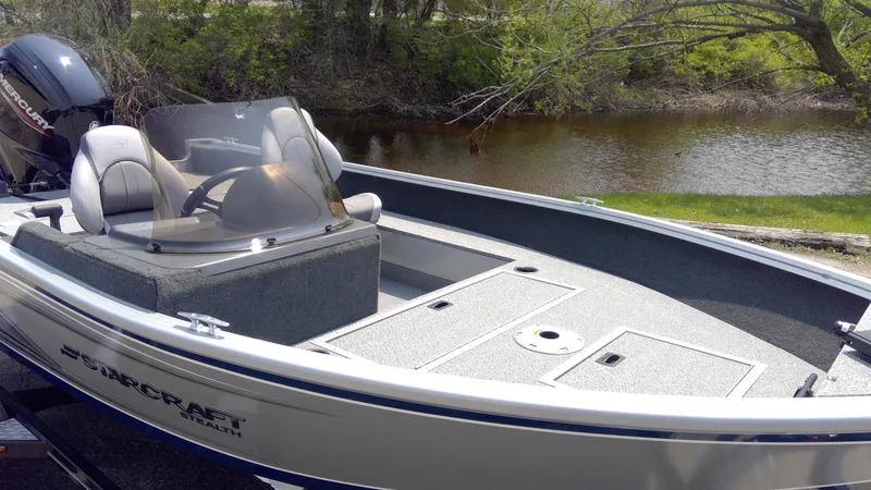 Slide: The Image of 2023 Starcraft Stealth 166 SC fishing boat by a river. - 2