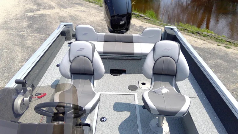 Slide: The Image of 2023 Starcraft Stealth 166 SC boat interior with dual seats and steering console. - 4