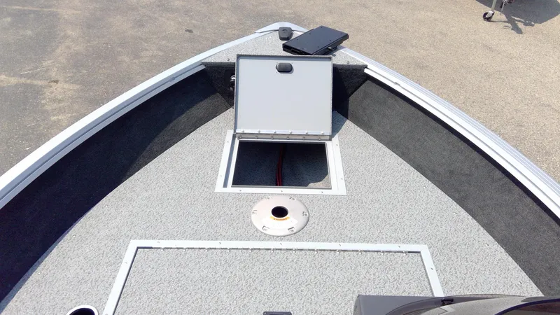 Slide: The Image of 2023 Starcraft Stealth 166 SC boat bow with open storage compartment. - 7