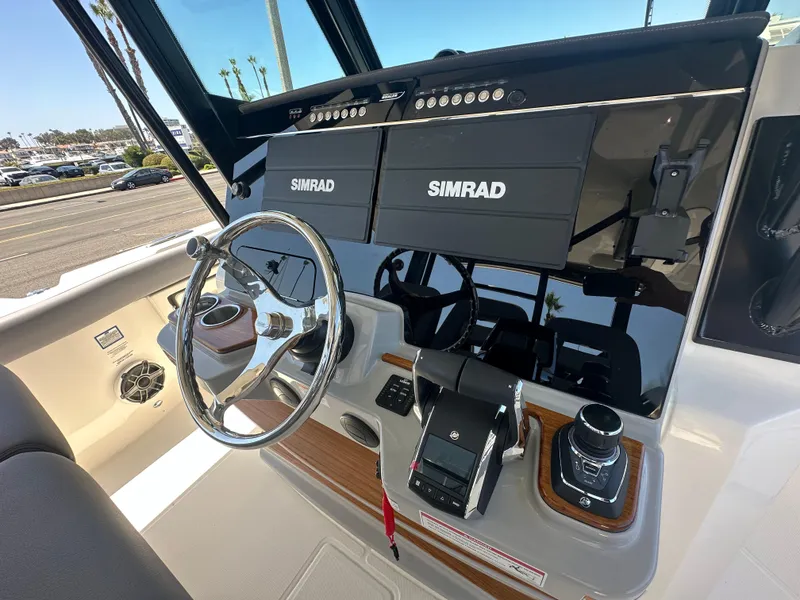 Slide: The Image of 2025 Boston Whaler 360 Outrage helm with Simrad electronics and modern controls. - 12