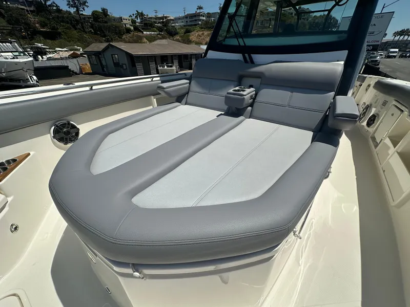 Slide: The Image of 2025 Boston Whaler 360 Outrage boat with luxurious seating and modern design. - 15
