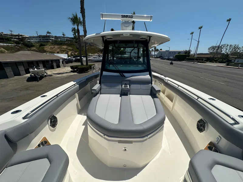 Slide: The Image of 2025 Boston Whaler 360 Outrage boat with spacious seating and modern design. - 16