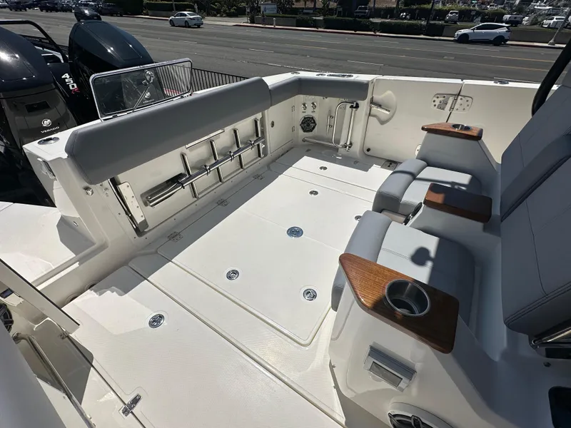 Slide: The Image of 2025 Boston Whaler 360 Outrage boat interior with seating and storage compartments. - 6