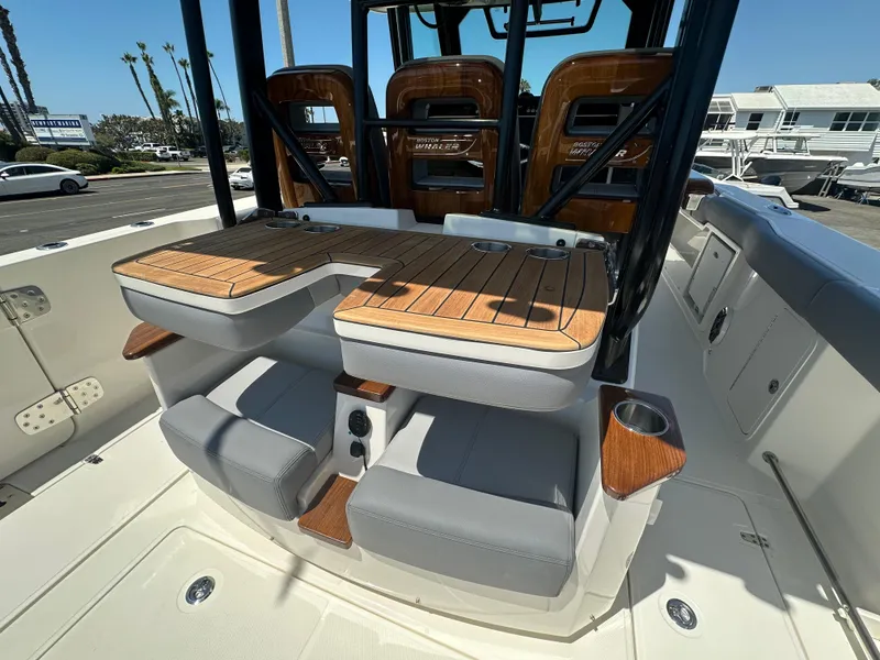 Slide: The Image of 2025 Boston Whaler 360 Outrage boat interior with teak seating and modern design. - 9