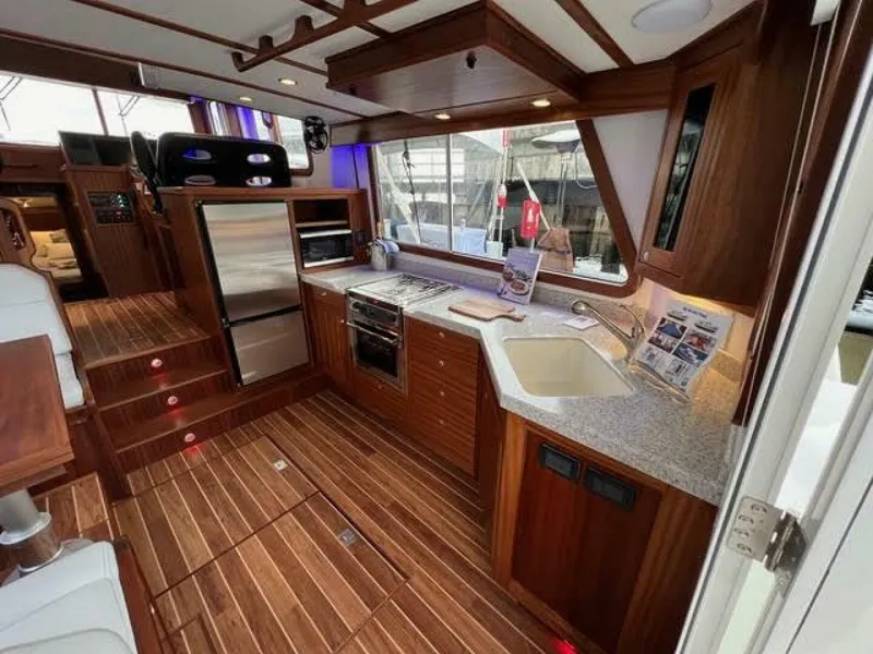 Slide: The Image of Luxurious 2024 Nordic Tug 40 interior with modern kitchen and wooden flooring. - 15