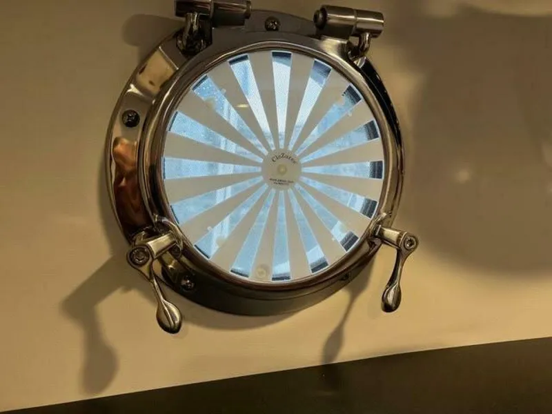 Slide: The Image of 2024 Nordic Tug 40 porthole with sunburst design and chrome finish. - 25
