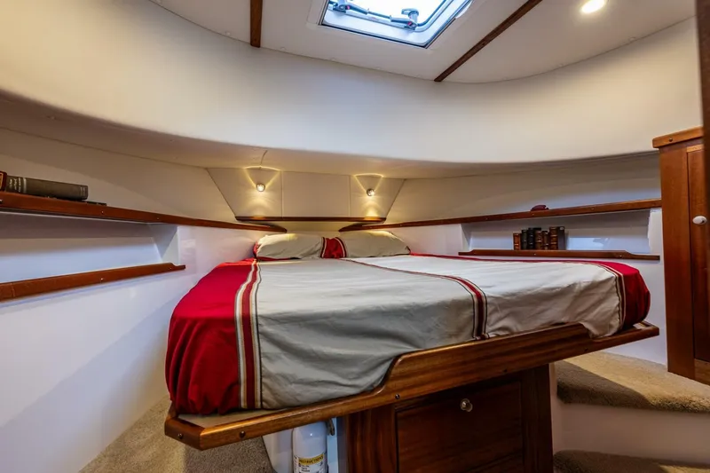 Slide: The Image of 2024 Nordic Tug 40 cabin interior with cozy bed and wooden accents. - 27