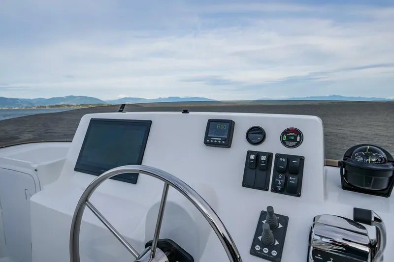 Slide: The Image of Nordic Tug 40 helm with navigation controls and sea view, 2024 model. - 31