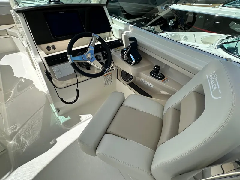 Slide: The Image of 2024 Boston Whaler 280 Vantage helm station with modern controls and comfortable captain's chair. - 11