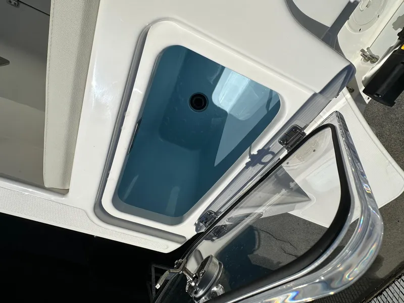 Slide: The Image of 2024 Boston Whaler 280 Vantage livewell compartment with open lid. - 13