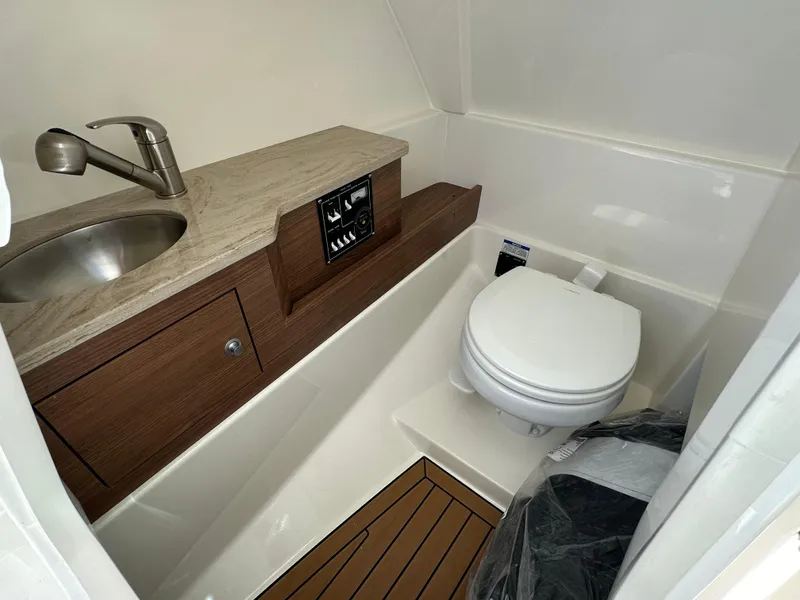 Slide: The Image of 2024 Boston Whaler 280 Vantage boat bathroom with sink and toilet. - 14