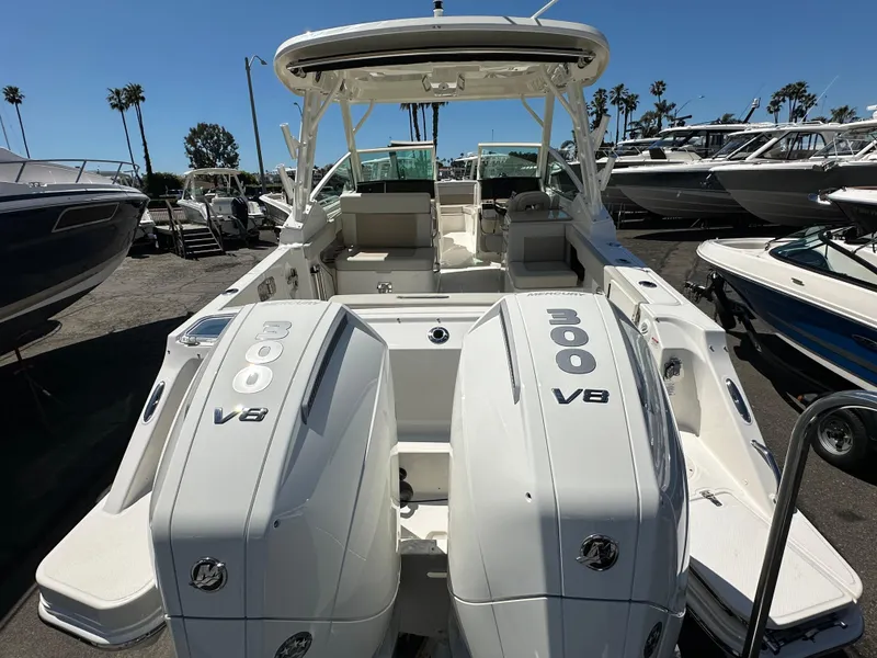 Slide: The Image of 2024 Boston Whaler 280 Vantage with twin 300 V8 engines at a marina. - 15