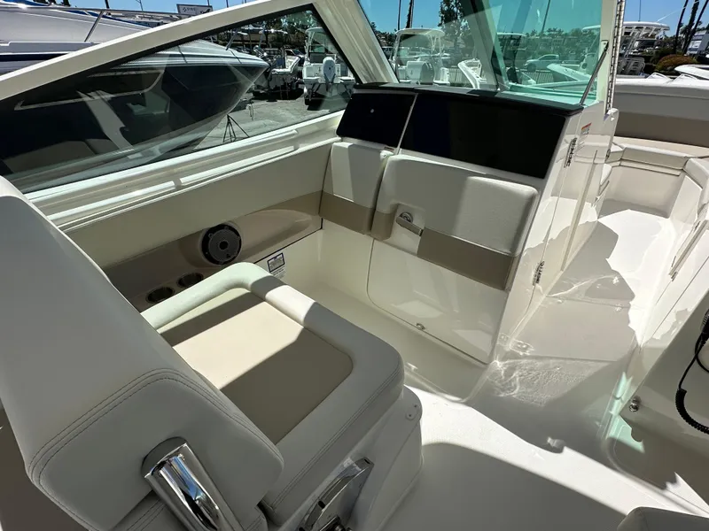 Slide: The Image of Interior view of 2024 Boston Whaler 280 Vantage boat with beige seating. - 19