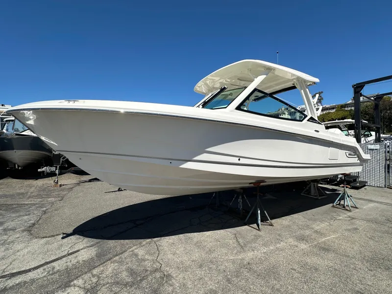 Slide: The Image of 2024 Boston Whaler 280 Vantage boat on display in a marina. - 21
