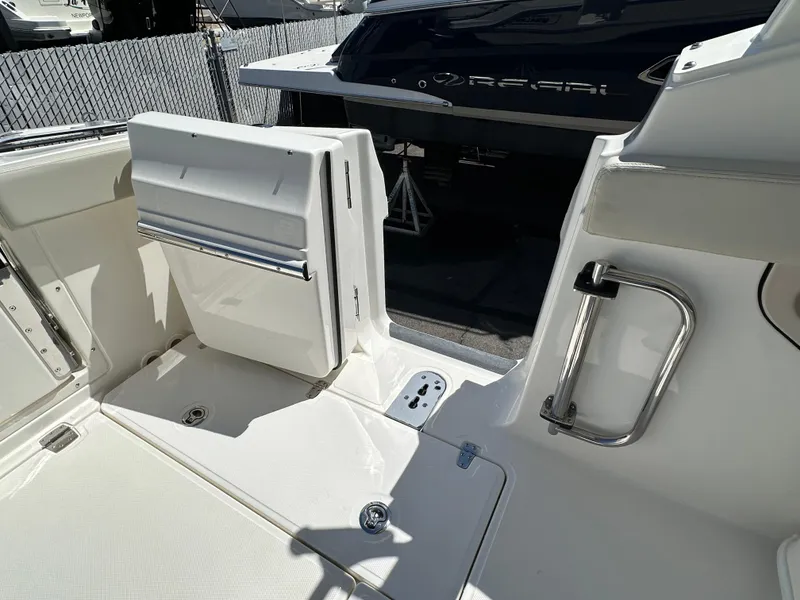 Slide: The Image of 2024 Boston Whaler 280 Vantage boat interior with open storage compartment. - 25