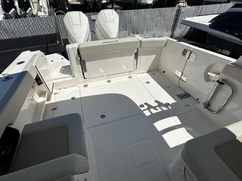 Slide: The Image of 2024 Boston Whaler 280 Vantage boat interior with spacious deck and seating. - 5