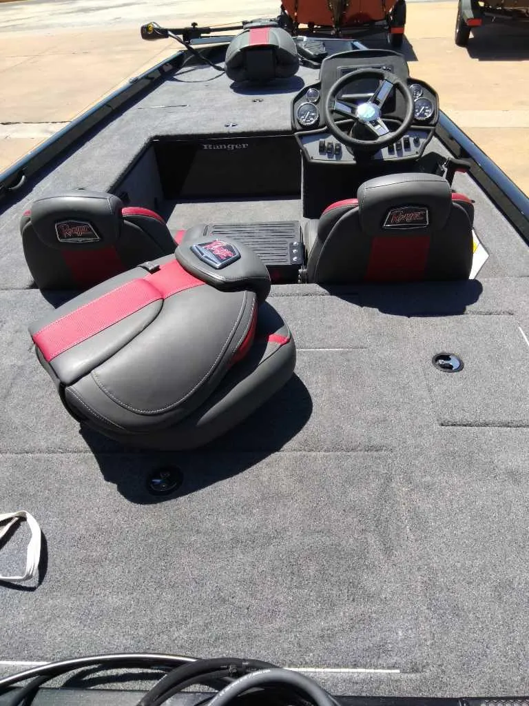 Slide: The Image of 2023 Ranger RT188C fishing boat interior with steering console and seating. - 2