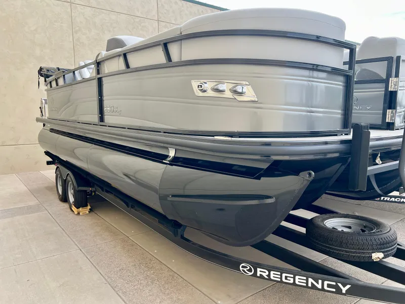 The Image of 2023 Regency 230 DL3 pontoon boat on trailer, side view. - 0