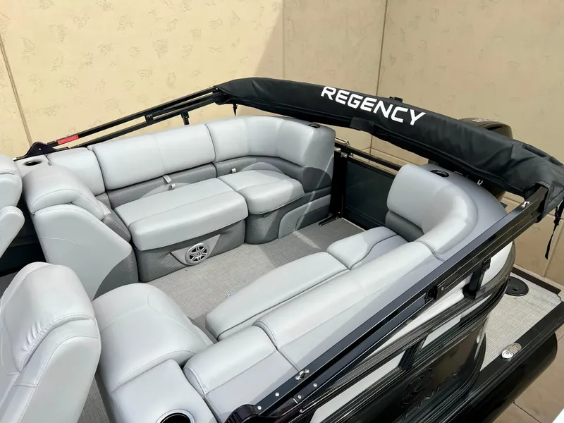 Slide: The Image of 2023 Regency 230 DL3 pontoon boat with luxurious seating and sleek design. - 2