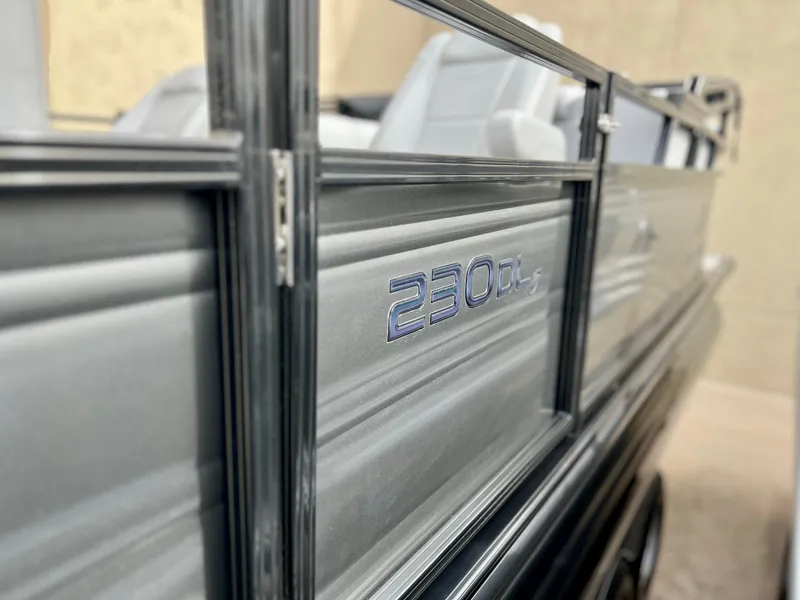 Slide: The Image of 2023 Regency 230 DL3 pontoon boat side view. - 5
