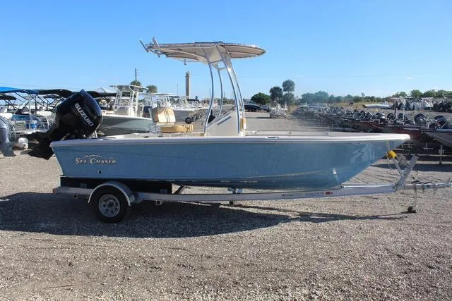 Slide: The Image of 2023 Sea Chaser 21 LX boat on a trailer in a marina. - 11