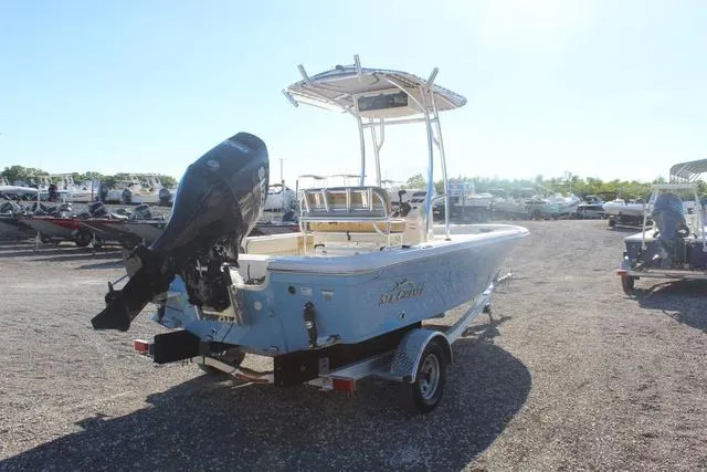 Slide: The Image of 2023 Sea Chaser 21 LX boat on a trailer, rear view in a boatyard. - 15