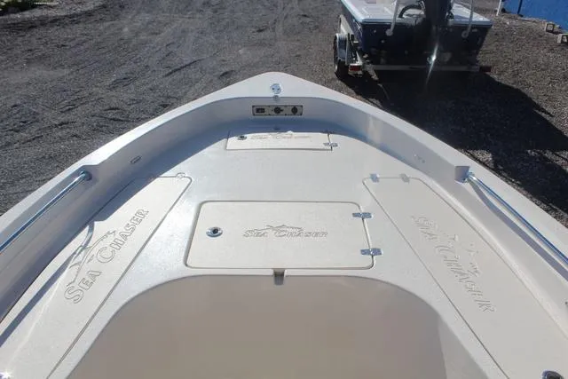 Slide: The Image of 2023 Sea Chaser 21 LX boat with open storage compartment on deck. - 22