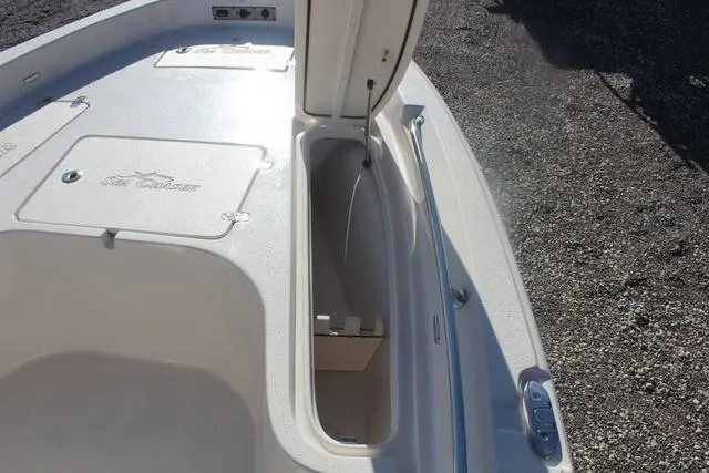 Slide: The Image of 2023 Sea Chaser 21 LX boat storage compartment with open hatch. - 25