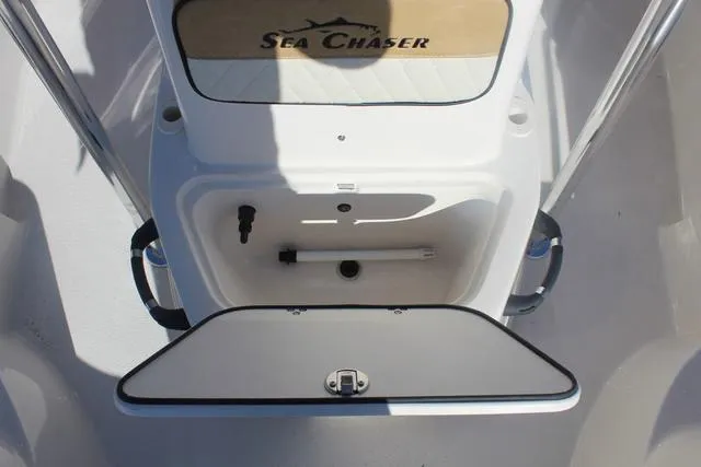 Slide: The Image of 2023 Sea Chaser 21 LX boat interior with tan seating and logo. - 27
