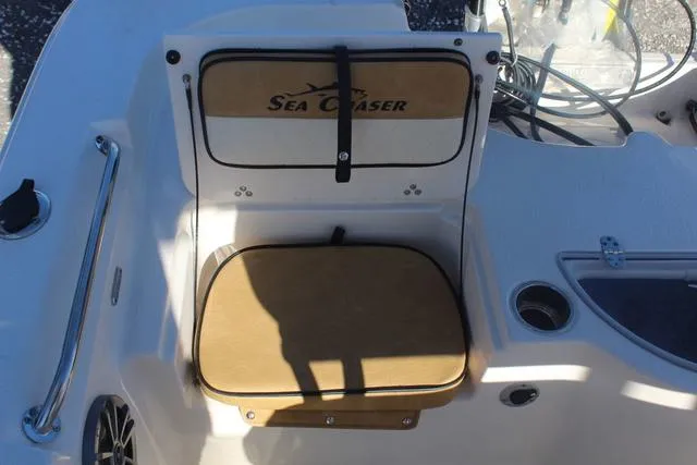 Slide: The Image of 2023 Sea Chaser 21 LX boat stern with storage compartments and outboard motor. - 33