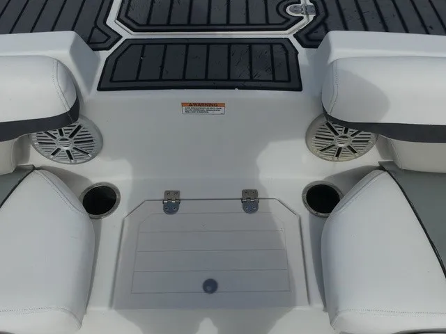 Slide: The Image of The image shows the seating area of a 2021 Starcraft SVX 191 OB boat with white cushions and speakers. - 17