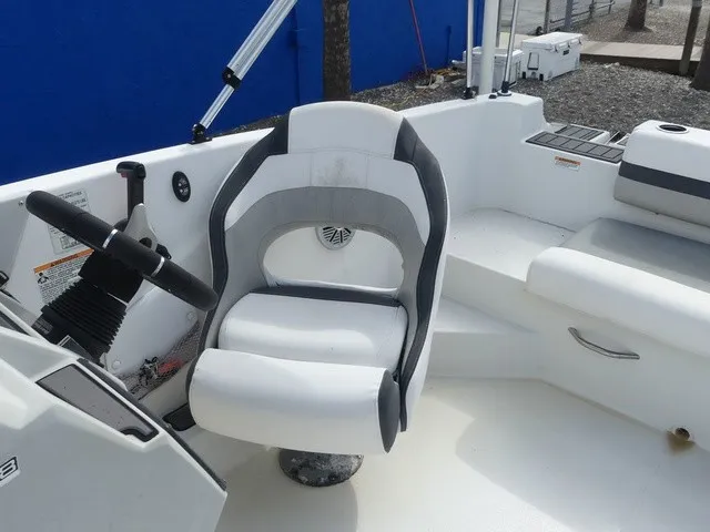 Slide: The Image of The image shows the helm of a 2021 Starcraft SVX 191 OB with a white captain's chair. - 20
