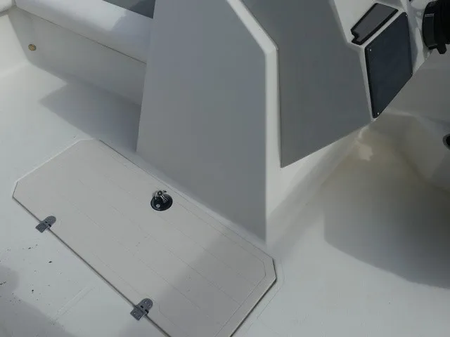 Slide: The Image of The image shows the cockpit of a 2021 Starcraft SVX 191 OB boat with white surfaces. - 23
