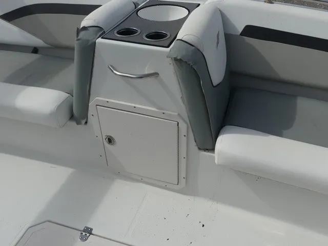 Slide: The Image of The image shows the seating area of a 2021 Starcraft SVX 191 OB boat with cup holders. - 24