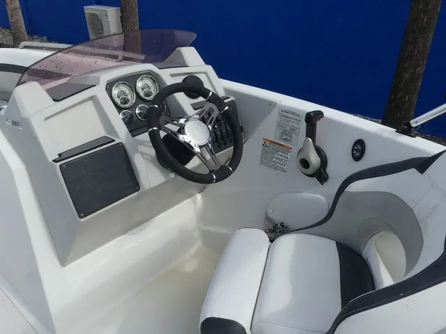 Slide: The Image of Helm of a 2021 Starcraft SVX 191 OB with steering wheel, gauges, and white seat. - 21