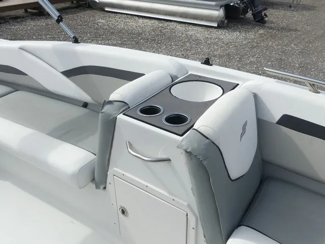 Slide: The Image of The image shows the seating area of a 2021 Starcraft SVX 191 OB boat with cup holders. - 19