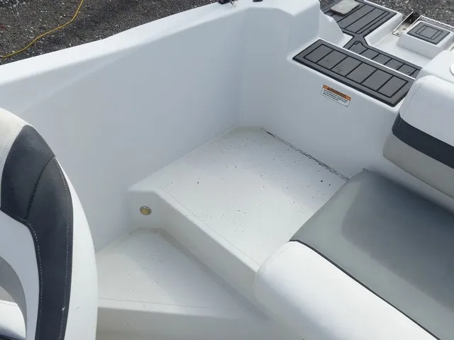 Slide: The Image of The image shows the interior of a 2021 Starcraft SVX 191 OB with white and gray seating. - 26
