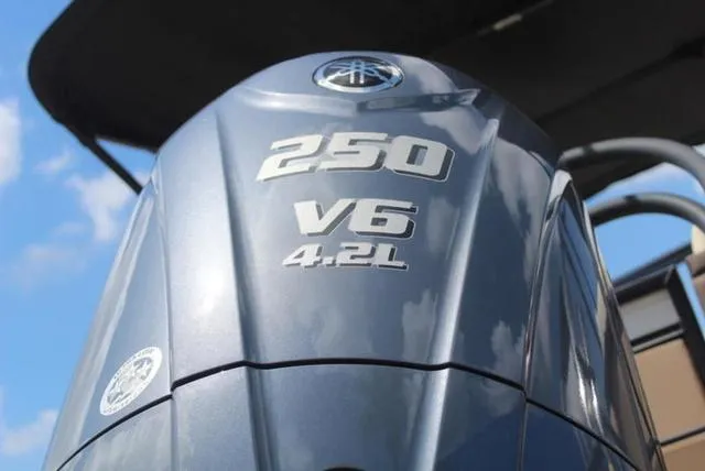 Slide: The Image of Luxurious seating area on 2023 Godfrey AquaPatio 255 SBC pontoon boat with cup holders and cooler. - 13