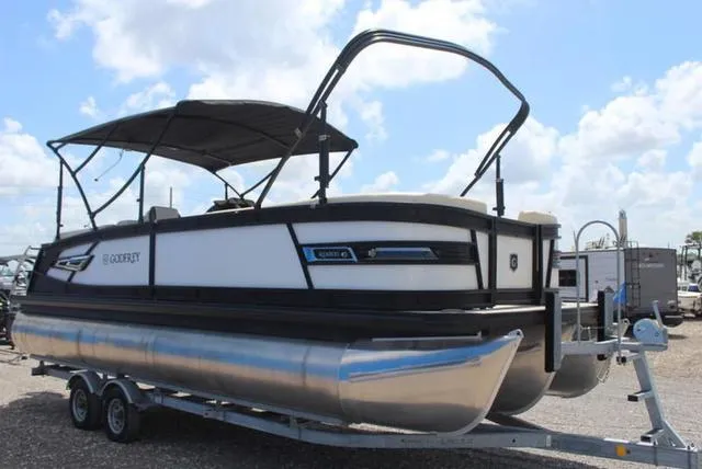 Slide: The Image of 2023 Godfrey AquaPatio 255 SBC pontoon boat on trailer under cloudy sky. - 3