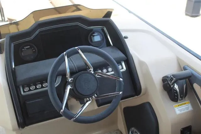 Slide: The Image of Close-up of a 2023 Godfrey AquaPatio 255 SBC boat propeller on a textured surface. - 9