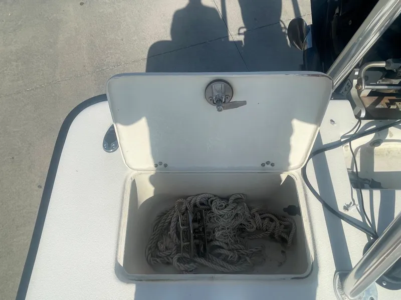Slide: The Image of Open storage compartment on a 2006 Intruder Pro Marine 20 boat with coiled rope inside. - 6