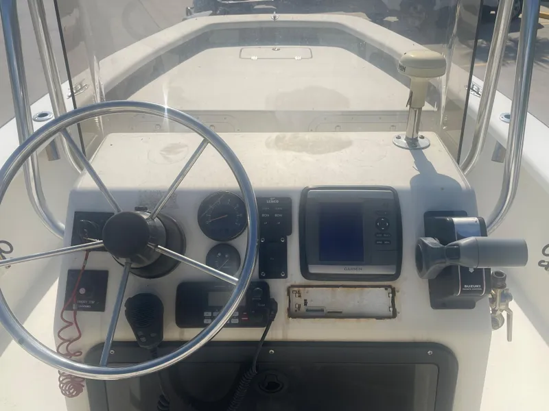 Slide: The Image of 2006 Intruder Pro Marine 20 boat dashboard with steering wheel and navigation instruments. - 9