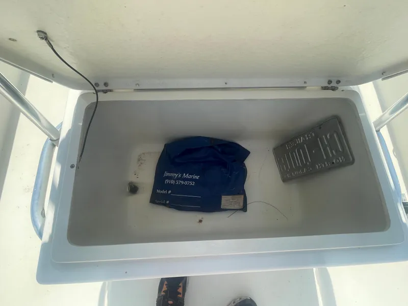Slide: The Image of Open storage compartment of a 2006 Intruder Pro Marine 20 boat. - 12