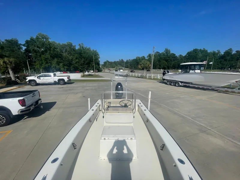 Slide: The Image of 2006 Intruder Pro Marine 20 boat in a parking lot with trucks and trees. - 13