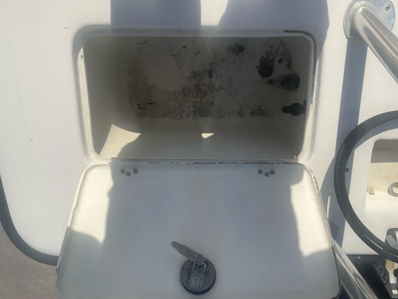 Slide: The Image of Open storage compartment on a 2006 Intruder Pro Marine 20 boat. - 7