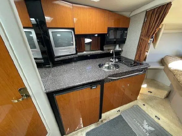 Slide: The Image of Interior of a 2004 Formula 31 Performance Cruiser with kitchenette and TV. - 11