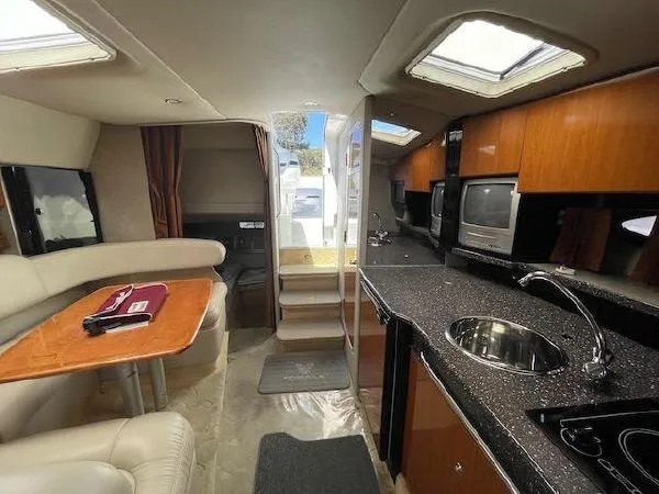 Slide: The Image of Interior of a 2004 Formula 31 Performance Cruiser with kitchen and seating area. - 17