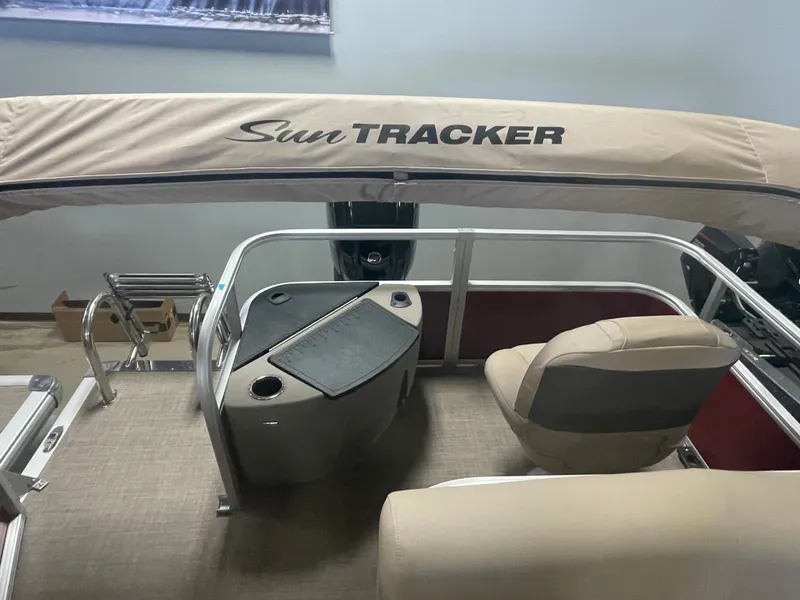 Slide: The Image of 2023 Sun Tracker Bass Buggy 18 DLX pontoon boat interior with helm and seating. - 10