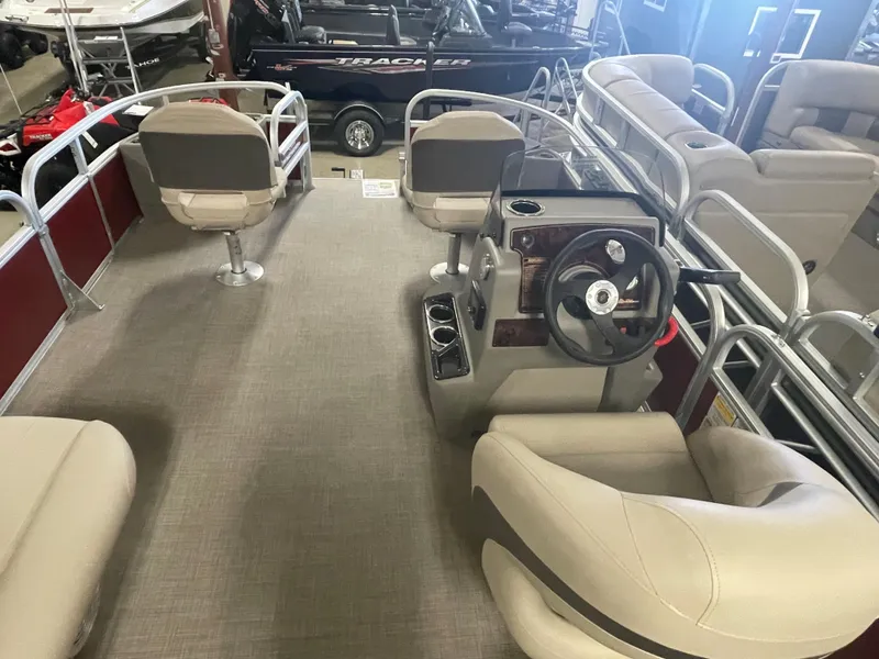 Slide: The Image of 2023 Sun Tracker Bass Buggy 18 DLX pontoon boat interior with steering console and seating. - 13