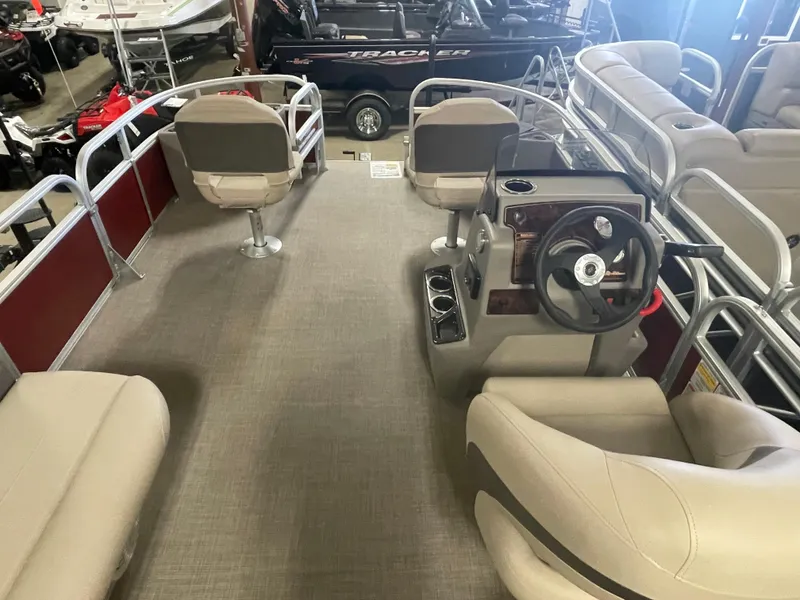 Slide: The Image of 2023 Sun Tracker Bass Buggy 18 DLX pontoon boat interior with seating and steering console. - 14